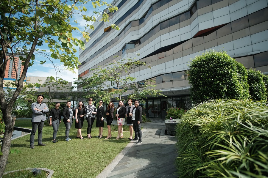 business people standing in a garden